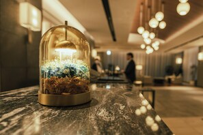 A glass dome with a light inside, placed on a marble surface in a hotel lobby. - Hotel JAL City Sapporo Nakajima Park (Sapporo)