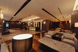 A spacious lobby with a reception desk, seating area, and a television screen. - Hotel JAL City Sapporo Nakajima Park (Sapporo)