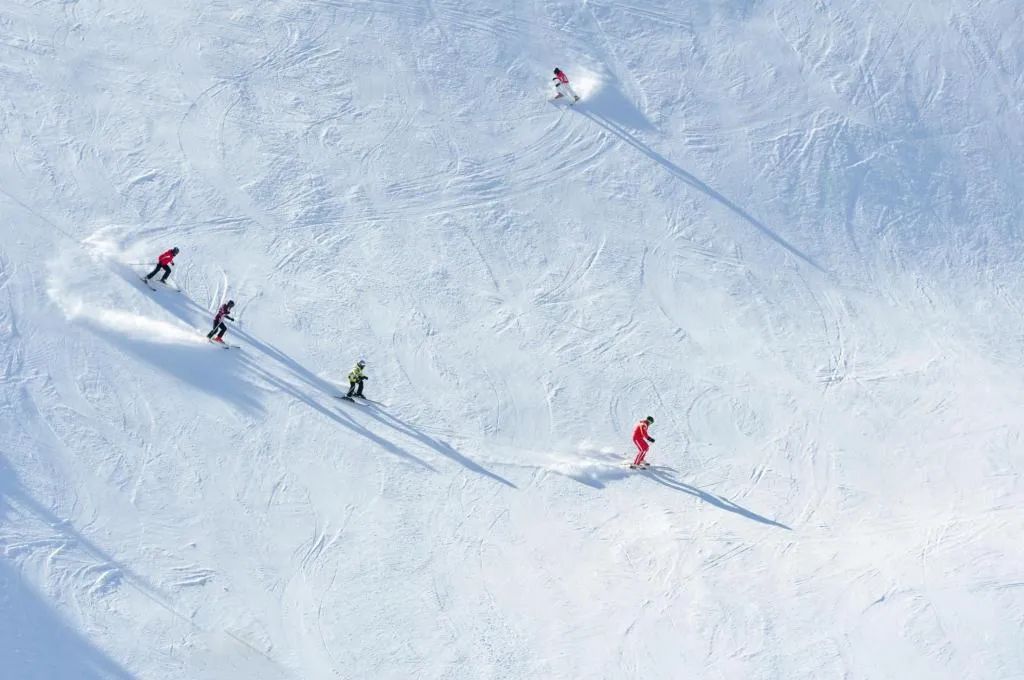 A snowy slope with skiers.