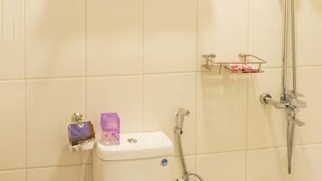 A bathroom with a toilet, sink, and shower.