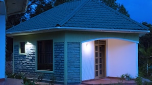 A small, single-story house with a stone facade and a tiled roof. - Tooro Fairway Hotel (Fort Portal)