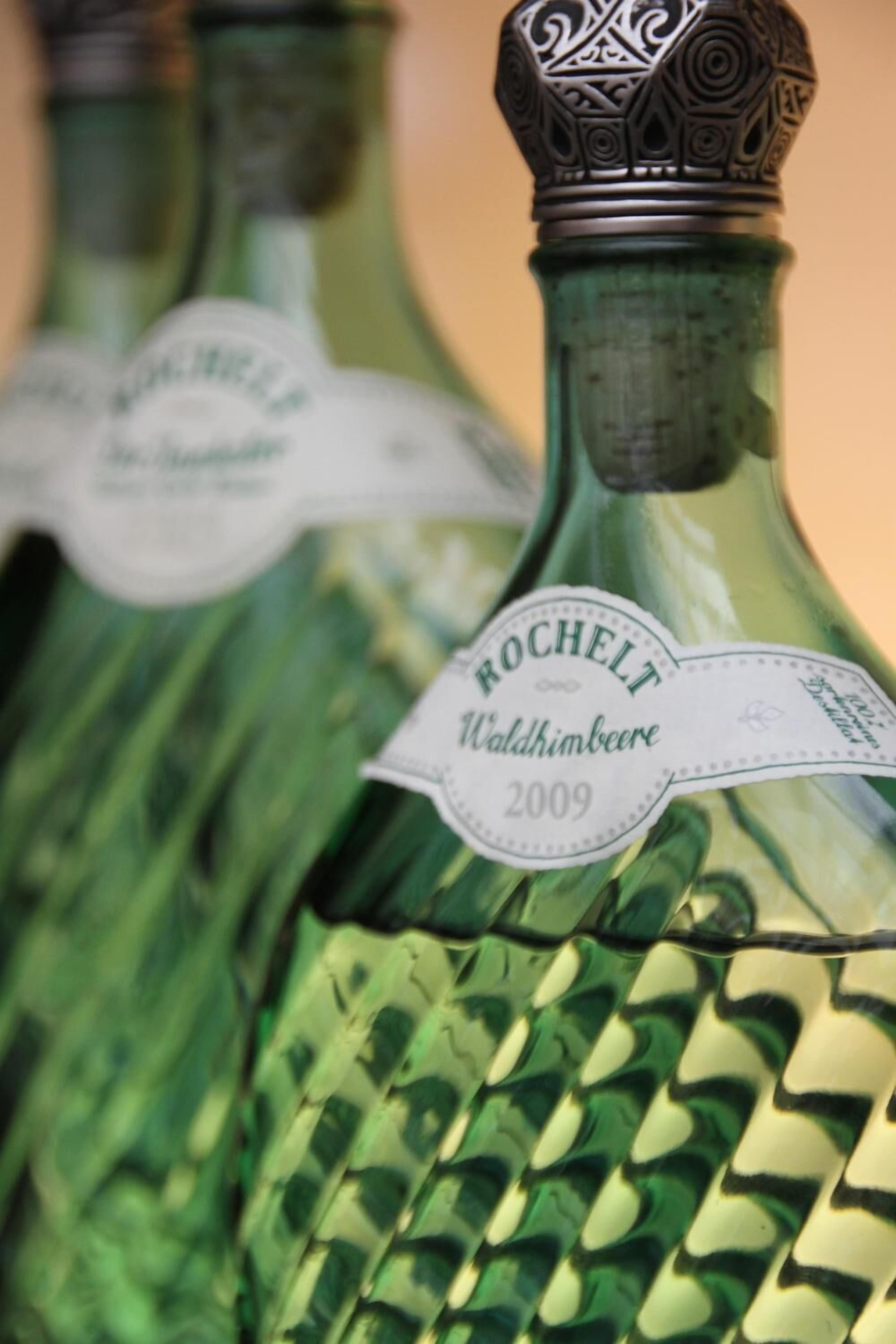A close-up of a bottle with a label reading "Rocchelt Waldhimbeere 2009".
