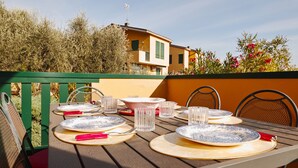A table set outdoors with plates, glasses, and cutlery.