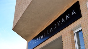A sign with the text "HOSTAL LADYANA" on a brick building. - Hostal Lady Ana Maria (Collado Villalba)