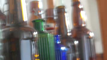 A row of glass bottles on a wooden shelf.