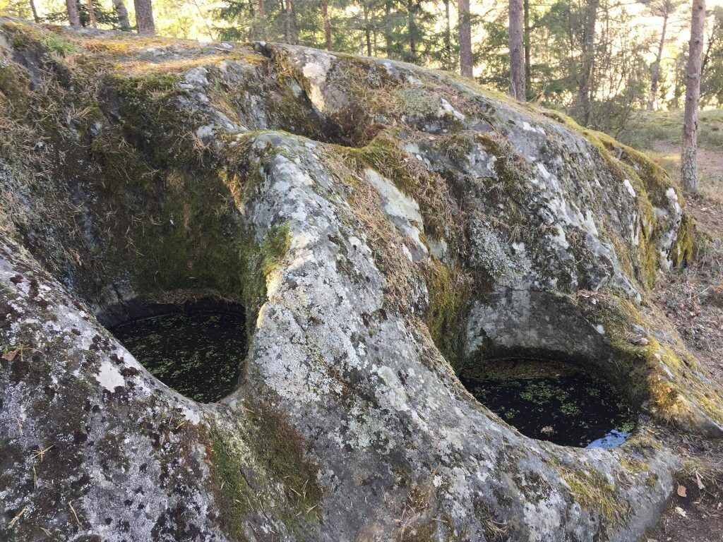 A natural rock formation with two openings.