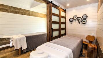 Relax in a serene space with a large bed, bedside table, and wooden bench.