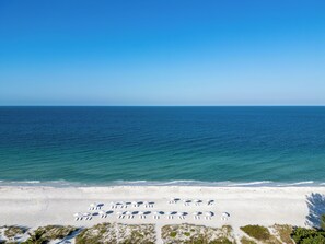On the beach, white sand, sun loungers, beach umbrellas