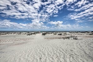 A sandy beach with dunes and a clear sky. - Beachside St Augustine Resort Condo, 6 Mi to Dtwn! (St. Augustine Beach)