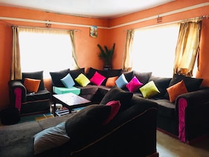 Una sala de estar con dos sofás, una mesa de centro y una planta en maceta.