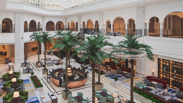 A spacious atrium with a high ceiling, multiple levels, and a central seating area with a circular fire feature. - Sheraton Yinchuan (Yinchuan)