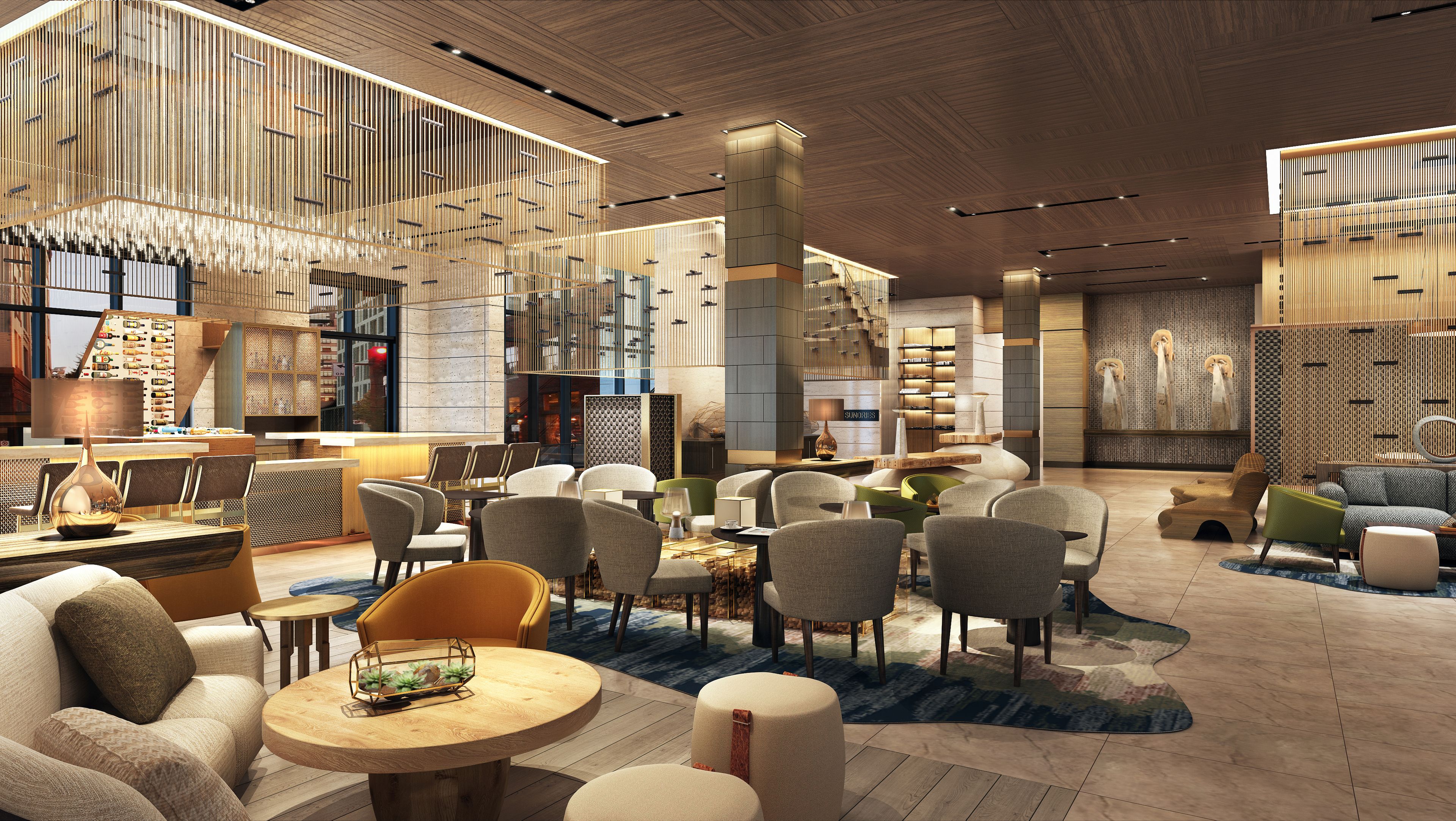 Un moderno vestíbulo de hotel con una zona de estar central, un bar y una escalera.