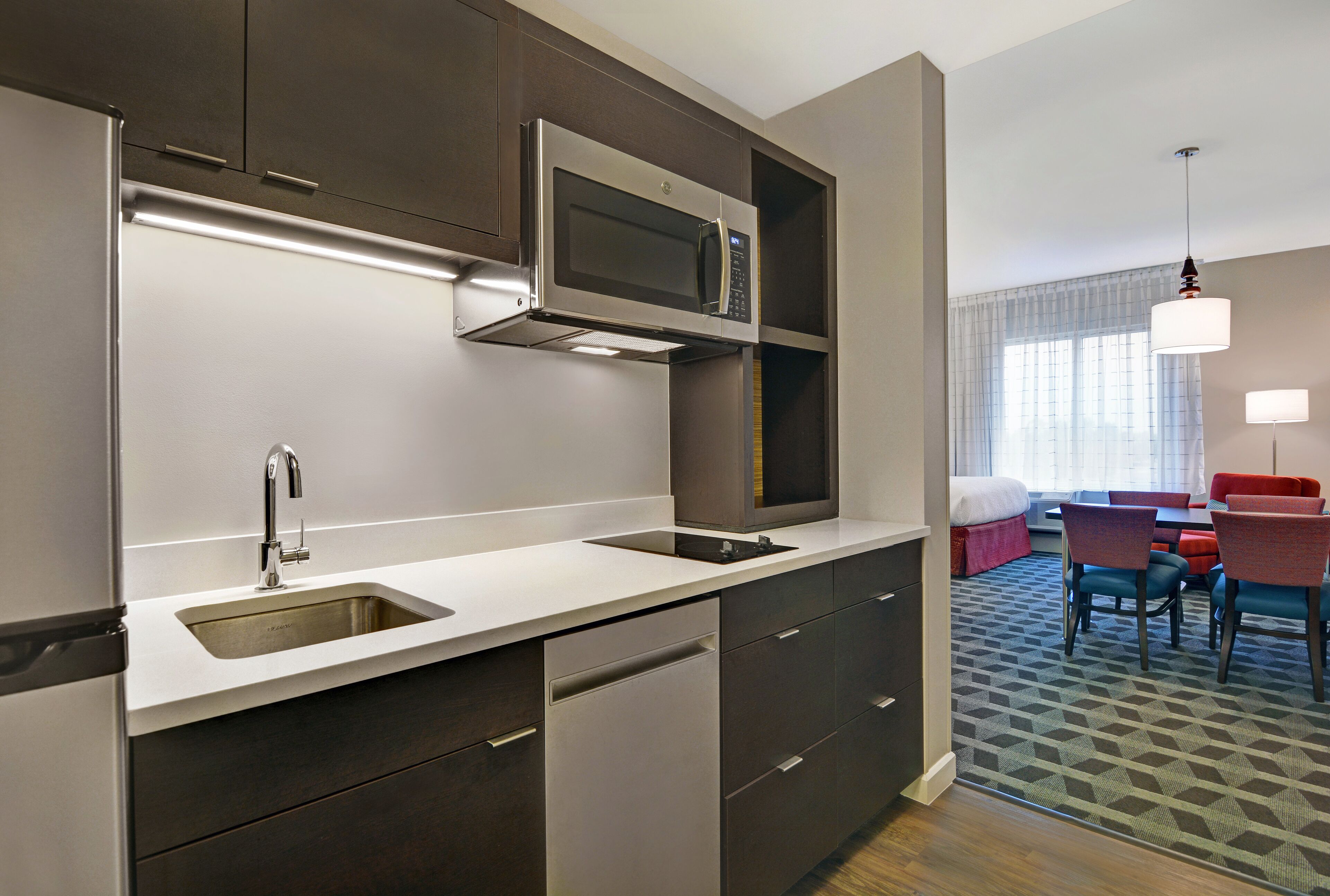 A modern kitchen with stainless steel appliances, a built-in microwave, and a double sink.