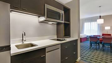 A modern kitchen with stainless steel appliances, a built-in microwave, and a double sink.