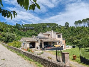 A two-story house with a paved driveway, a covered porch, and a fenced yard. - Les Chataigniers (Saint-Sebastien-d'Aigrefeuille)
