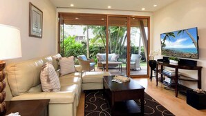 A modern living room with a sofa, coffee table, and TV. - Aloha Villas 3, Oceanfront Townhouse, Steps to The (Kihei)