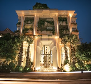 A grand building with a symmetrical facade, large columns, and a central entrance with a decorative gate. - Hari Residence & Spa (Siem Reap)
