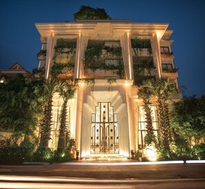 A building with a grand entrance, large columns, and a well-lit facade. - Hari Residence & Spa (Siem Reap)