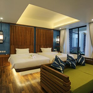 A hotel room with two beds, a wooden bench, and a view of the outside. - Hari Residence & Spa (Siem Reap)