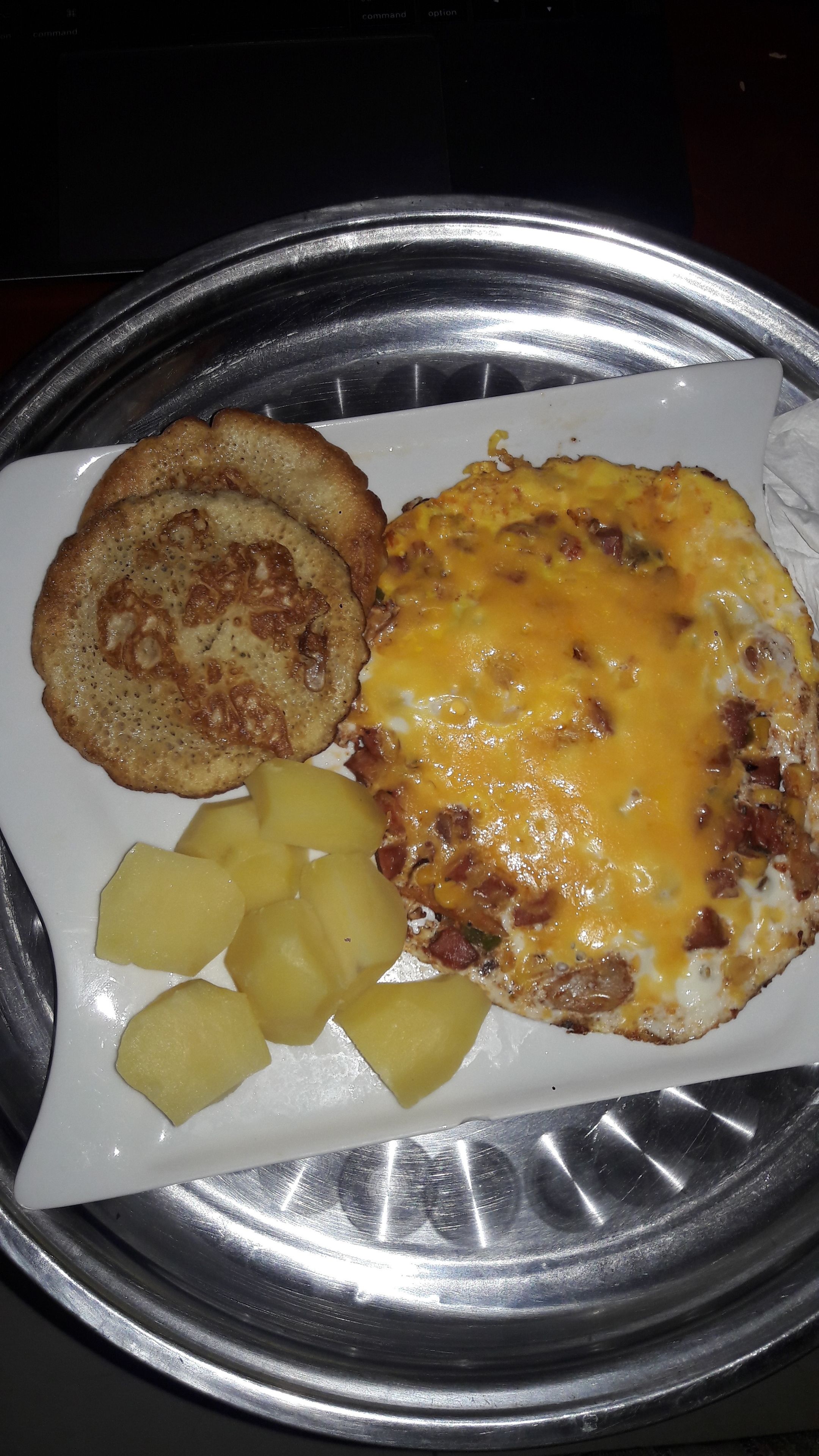A breakfast plate with scrambled eggs, toast, and diced potatoes.