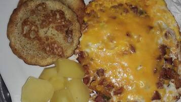 A breakfast plate with scrambled eggs, toast, and diced potatoes.