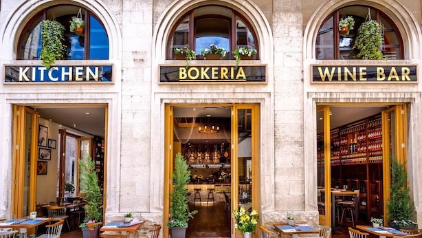 A building with three storefronts labeled "KITCHEN," "BOKERIA," and "WINE BAR." - Abokamento Boutique Rooms (Split)