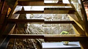 A wooden staircase with a stone wall background. - Historic Townhouse in Birgu Center (Il-Birgu)
