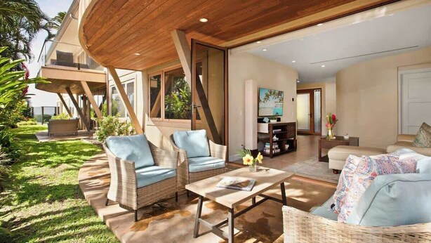 A modern living room with a wooden ceiling, a sofa set, a coffee table, and a TV. - Aloha Villas # 4, Luxury Oceanfront Townhouse, Ste (Kihei)