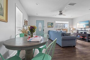 Relax in this open-plan living space with a dining area, sofa, and flat-screen TV.
