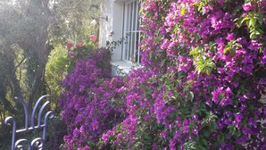 A building with a white exterior, a window with metal bars, and a balcony. - rent large family villa near the sea and nature (Roquebrune-Sur-Argens)