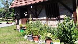 A rustic building with a tiled roof and a stone facade.