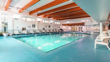 Relax by the pool surrounded by lounge chairs and natural light.