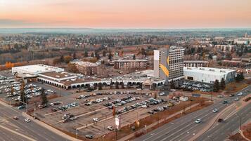 Adjacent to a commercial building, this expansive parking area offers ample space for vehicles.