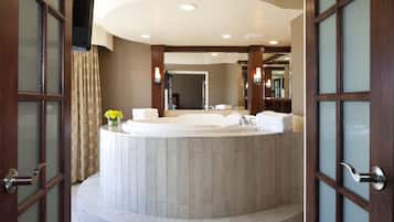 A modern bathroom with a freestanding bathtub, a large mirror, and a vanity with a sink.
