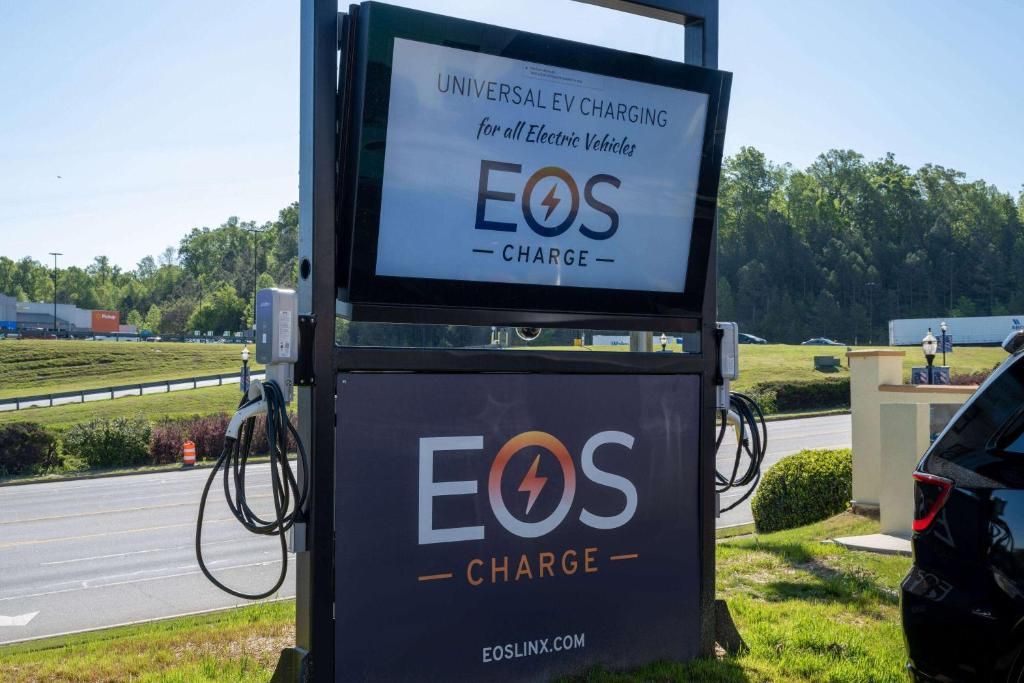 A charging station with a sign indicating it is for universal EV charging.