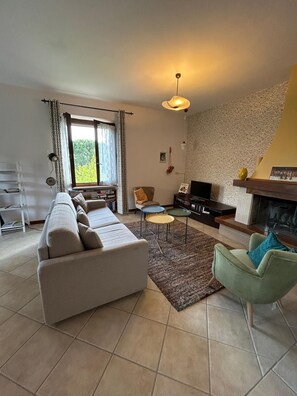 A living room with a sofa, armchairs, a television, a fireplace, and a bookshelf. - Lovely holiday house: private swimming pool, olive tree garden, cultural setting (Panicale)