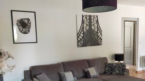 A modern living room with a grey sectional sofa, a white coffee table, and artwork on the walls. - Grillon in the Enclave des Papes, 4 km from Château de Grignan.  (Grillon)