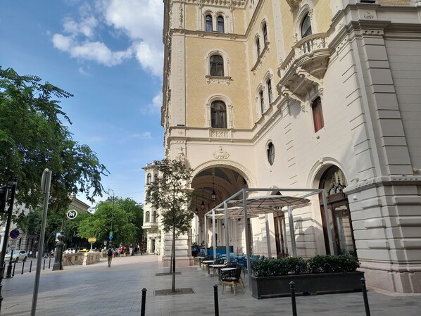 A historic building with classical architecture, including arched windows and detailed stonework.