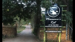 A sign for Masasana's Rest with contact information and a symbol of a bird and tree. - Masasana's Rest (Mbombela)