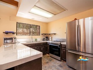 Fridge, microwave, coffee/tea maker, cookware/dishes/utensils
