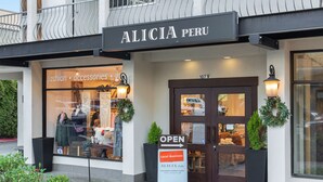 A storefront with a sign reading "ALICIA PERU" and a signboard indicating "OPEN Local Business." - Kasa Bellevue Seattle (Bellevue)