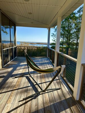 A wooden deck with a hammock, overlooking a body of water and trees. - Private, 7-acre waterfront retreat on Winter Harbor Haven (Port Haywood)
