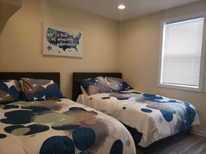 A bedroom with two beds, a map artwork on the wall, and a window with blinds. - Large house perfect for large families! Off Street Parking for 2 cars (Washington)