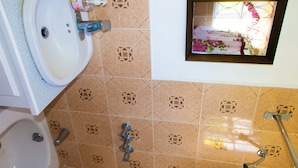 A bathroom with a sink, toilet, and shower. - Belle Air Paradise JM (Runaway Bay)