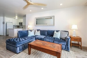 A living room with a sectional sofa, a wooden coffee table, and two bedside tables with lamps. - D104-Stunning Ocean/Pier Views, North Coast Village (Oceanside)