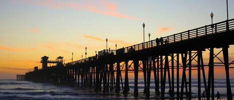 A pier extending into the water with a structure at the end, likely a lookout or control tower.