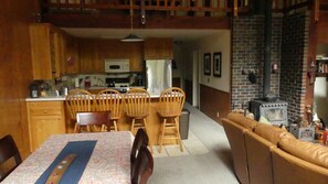 Cozy living space with a dining area, stove, and comfortable seating areas.