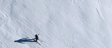 A snowy slope with a skier.