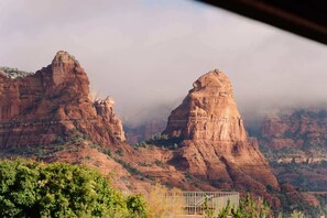 A mountainous landscape with prominent rock formations and a bridge in the foreground. - Eagle Dancer Guest Suite | Wellness Spa & Trails (Sedona)