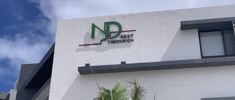 A building with a sign that reads "ND NEXT DIMENSION".